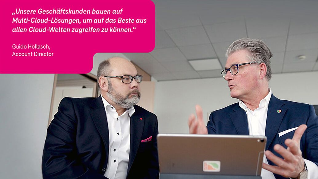 Zwei Geschäftsmänner sitzen vor einem laptop und diskutieren