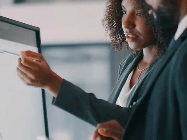 A woman giving a presentation on a screen in the office