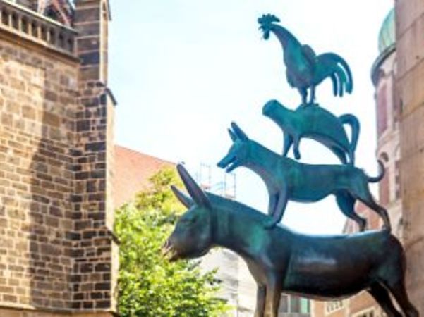 Skulptur der Bremer Stadtmusikanten zwischen historischen Gebäuden in Bremen.
