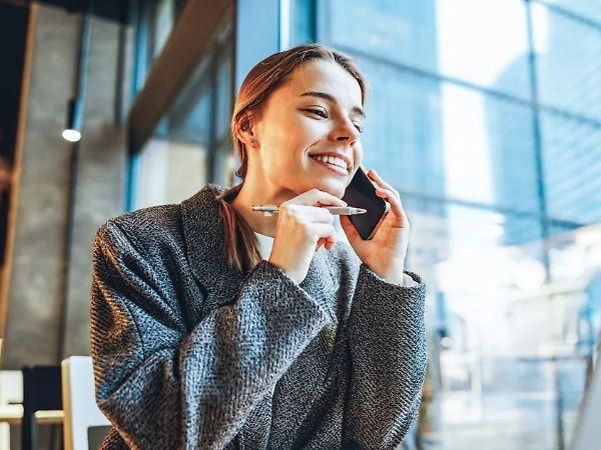 “A person using a smartphone in a modern office”