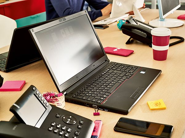 A black laptop, connected to CompanyFlex, is sitting on a desk.
