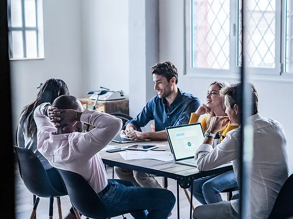 People are sitting around a table and working together during a meeting