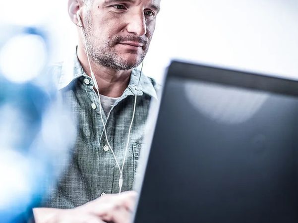 A person is working at a desktop computer in the office.