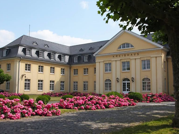 The Bernkastel-Wittlich District Administration building, with flowerbeds in the foreground.