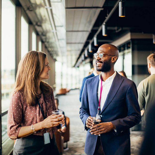 A man and a woman are chatting at a Telekom event for public sector clients