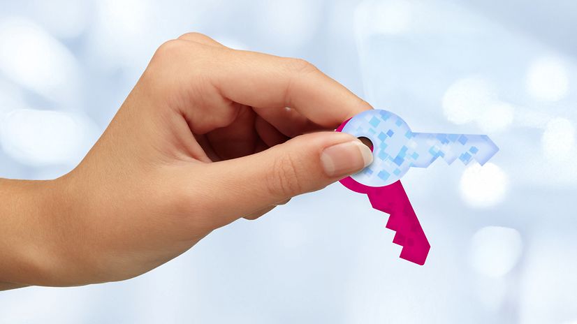 A hand holding the key for Magenta Security Key Management.ID.