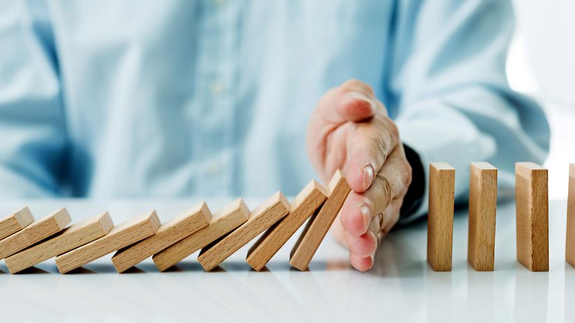 Hand stops falling wooden blocks for Incident Response Services.