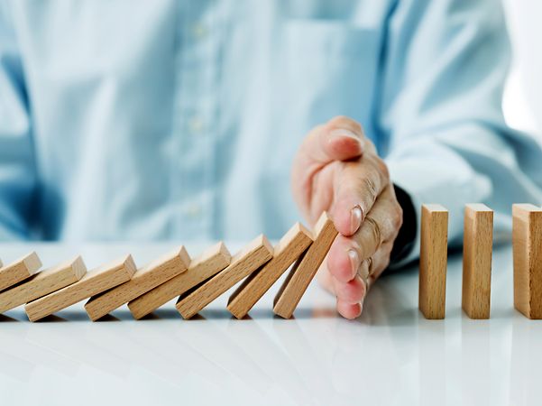 Hand stops falling wooden blocks for Incident Response Services.